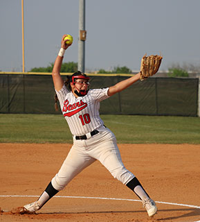 Softball pitcher in the middle of a pitch